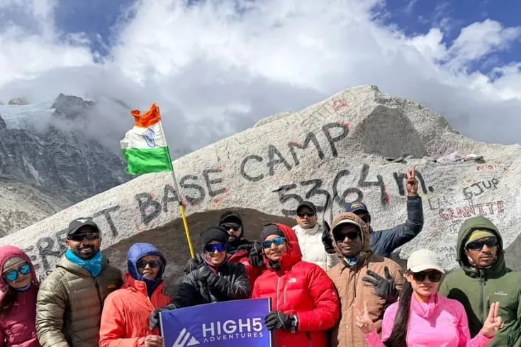 Everest Base Camp height: The May 2026 Everest Base Camp group with the High 5 banner. Trekkers holding a High 5 Adventures banner, with an Indian flag, in front of the painted 5,364 m boulder at Everest Base Camp, May 2026. Trekkers holding a High 5 Adventures banner, with an Indian flag, in front of the painted 5,364 m boulder at Everest Base Camp, May 2026